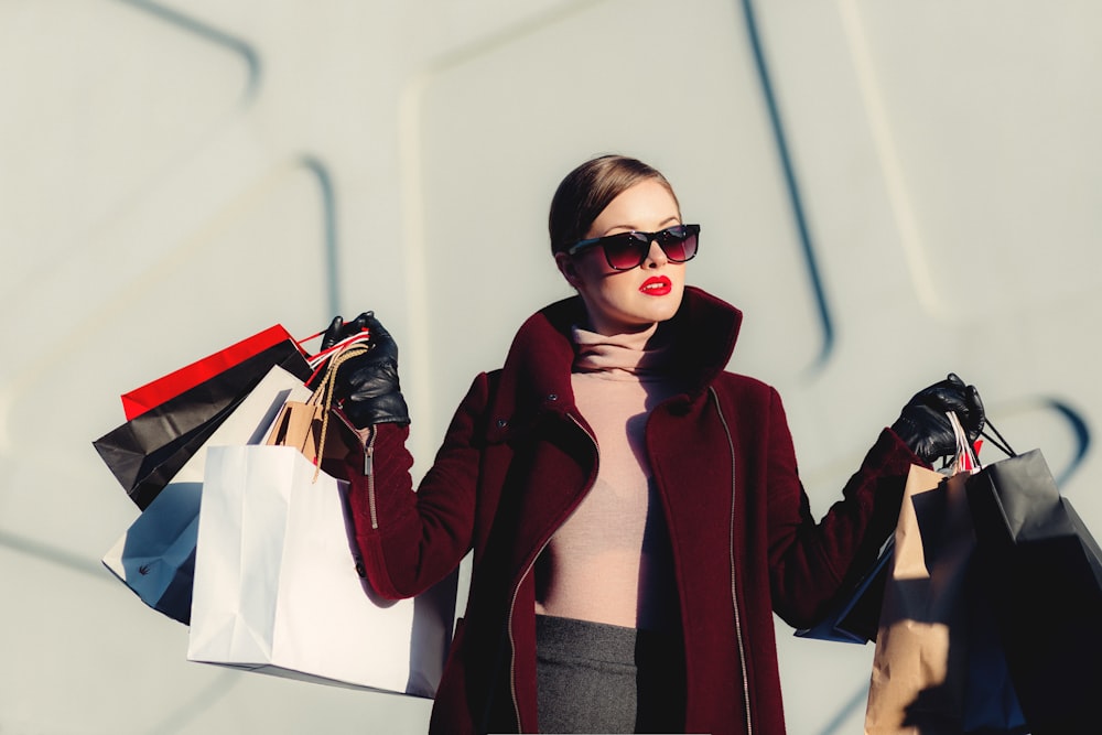 A shopper carrying several shopping bags